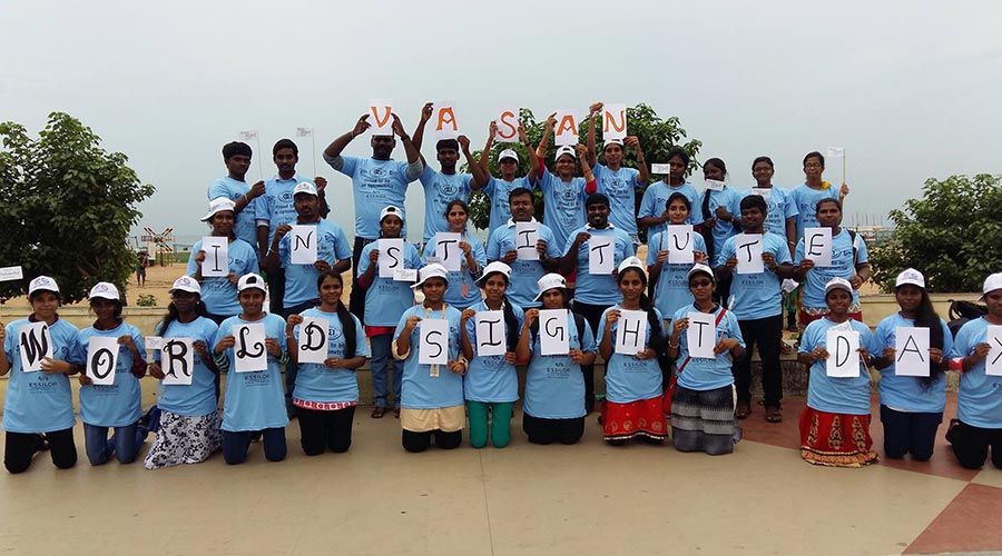 Students spelling out Vasan Institute on World Sight Day